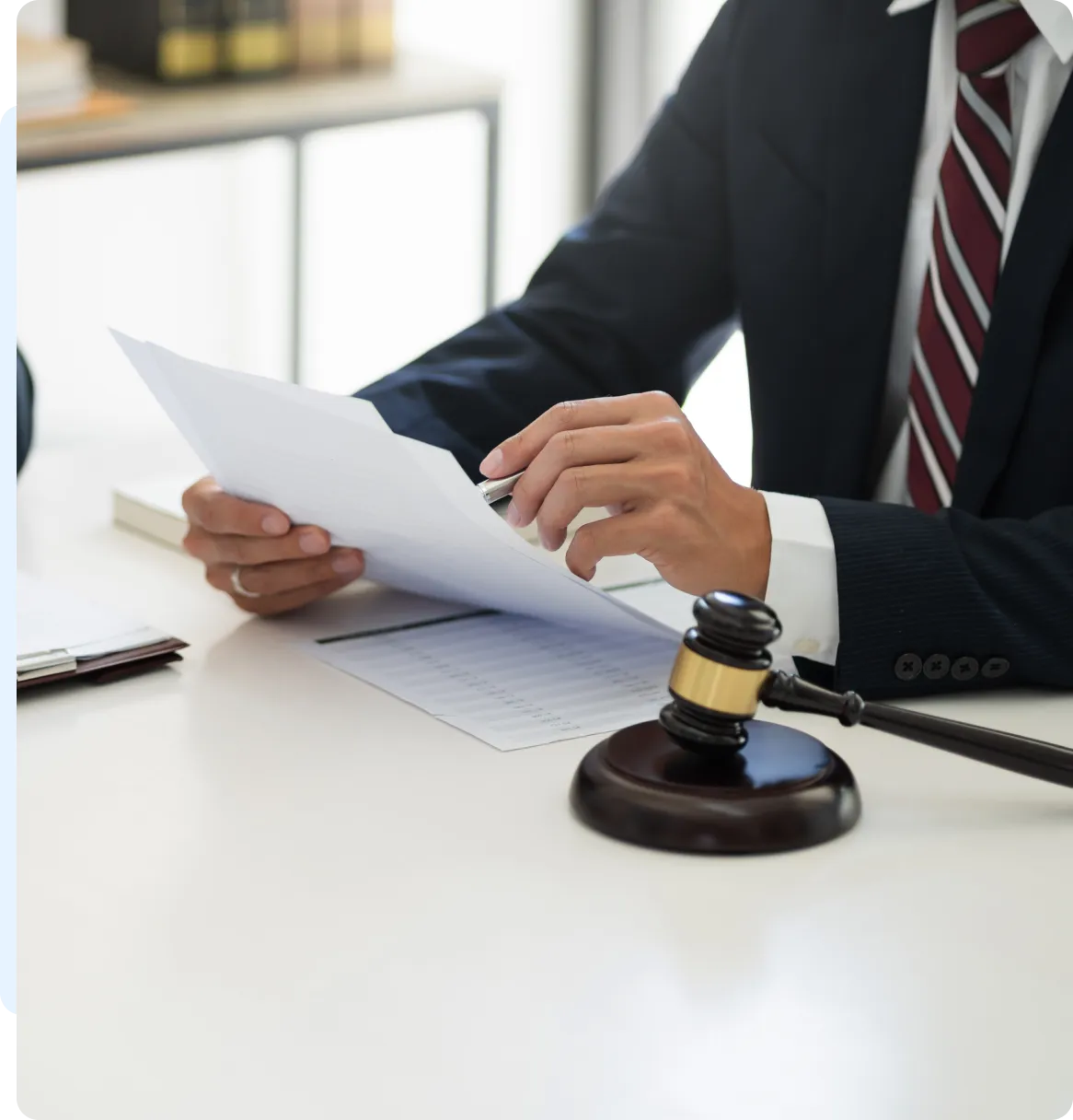 Lawyer reviewing legal documents, gavel.