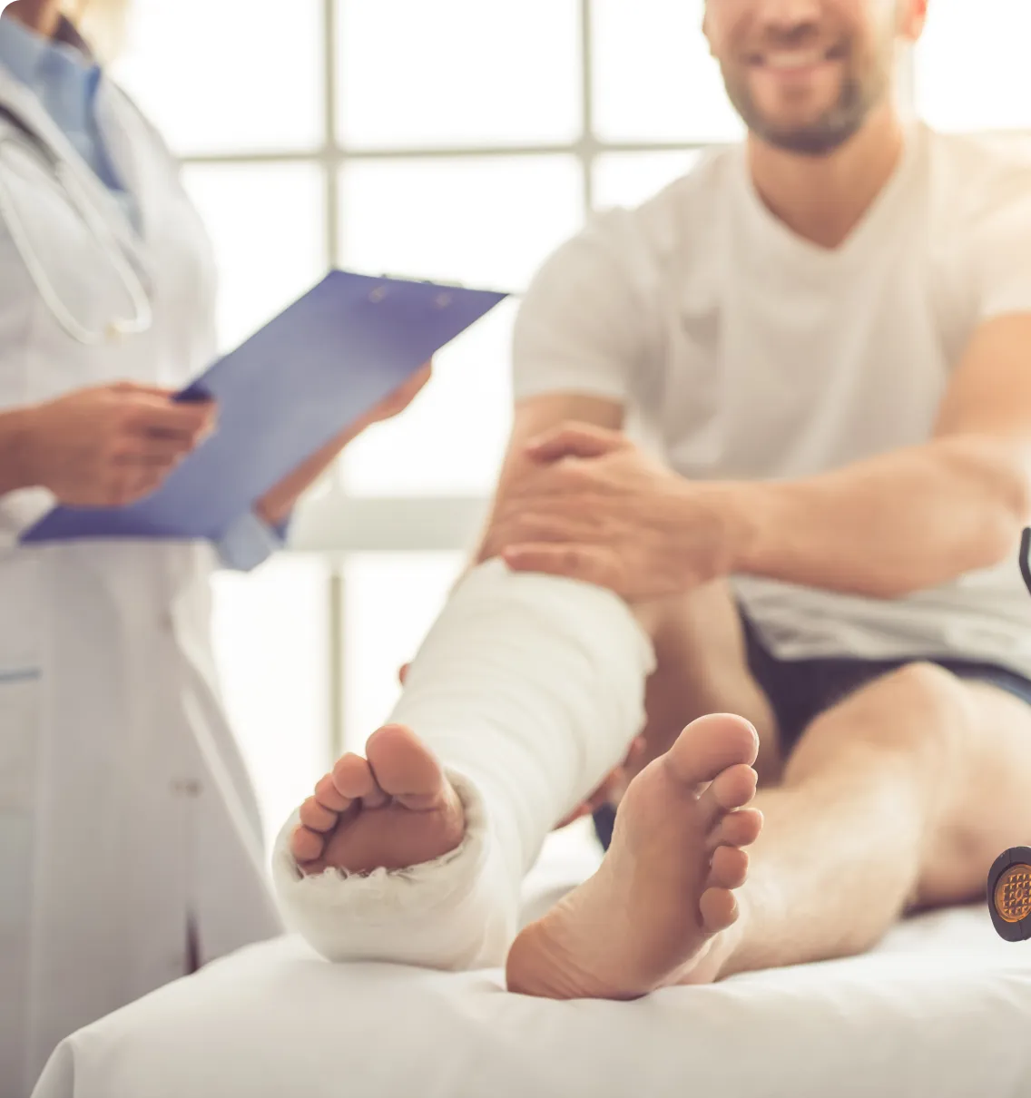 Man with leg cast at doctor's appointment.