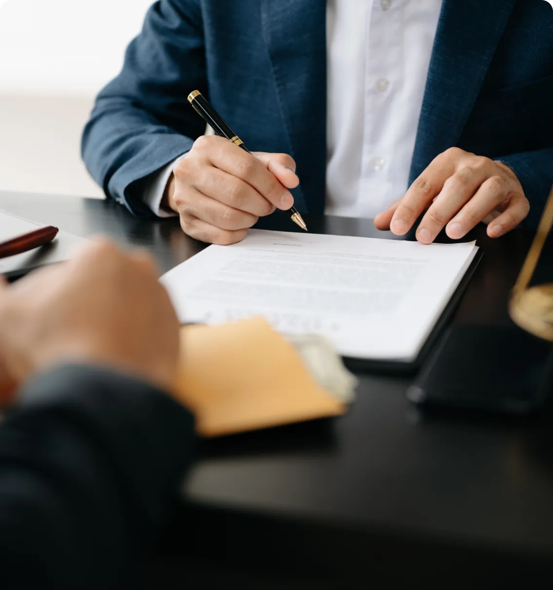 Businessperson signing legal document.