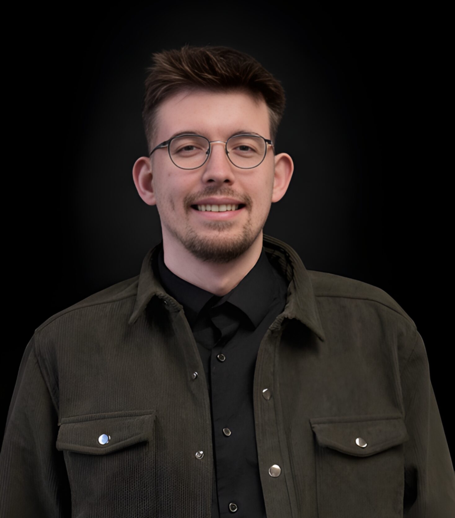 Man wearing glasses and a dark jacket.